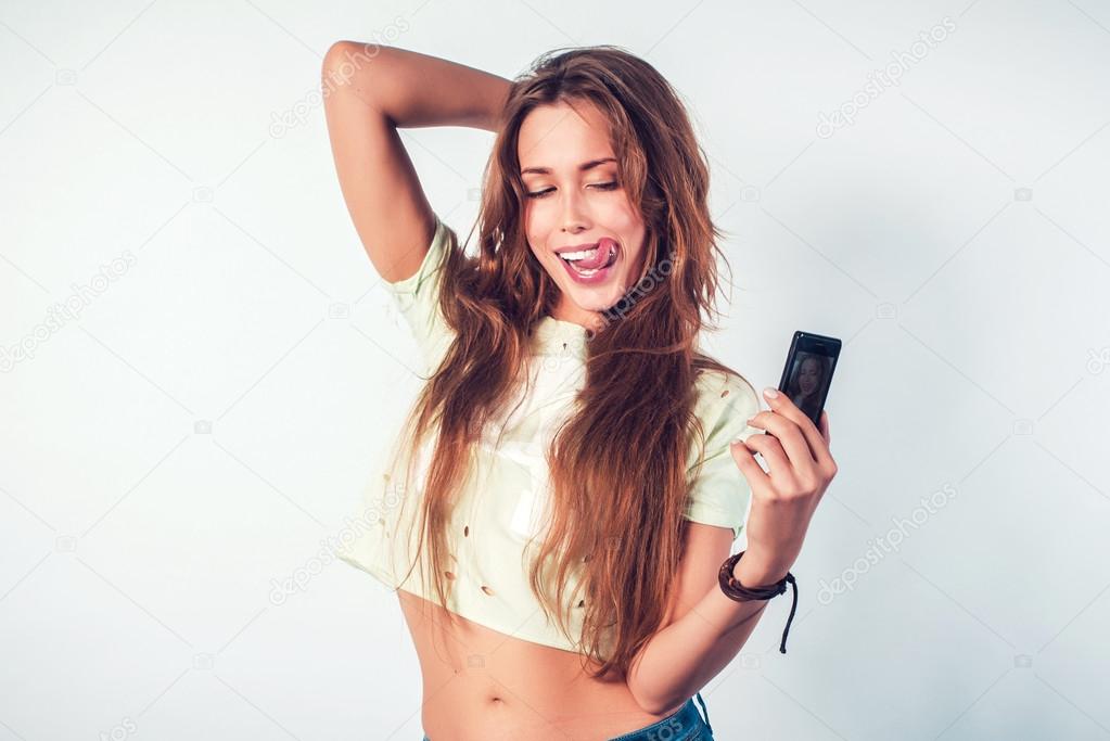 Happy smiling woman taking selfie with smartphone.