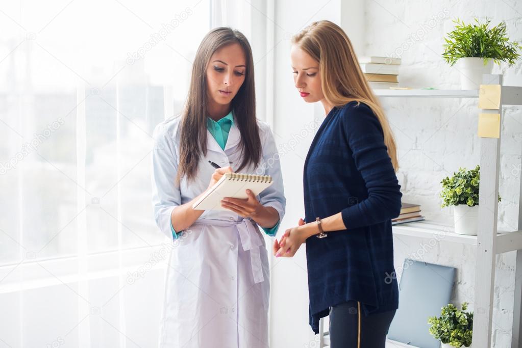 Woman doctor explaining diagnosis prescribe to her female patient concept  healthcare, medical, hospital.