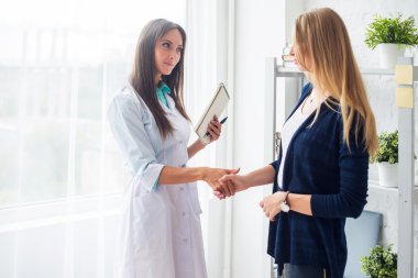 Woman medical doctor shaking hands with patient concept  healthcare, medical, hospital.
