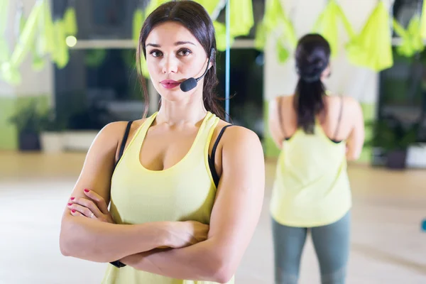 Female sports trainer with microphone — Stock Photo, Image