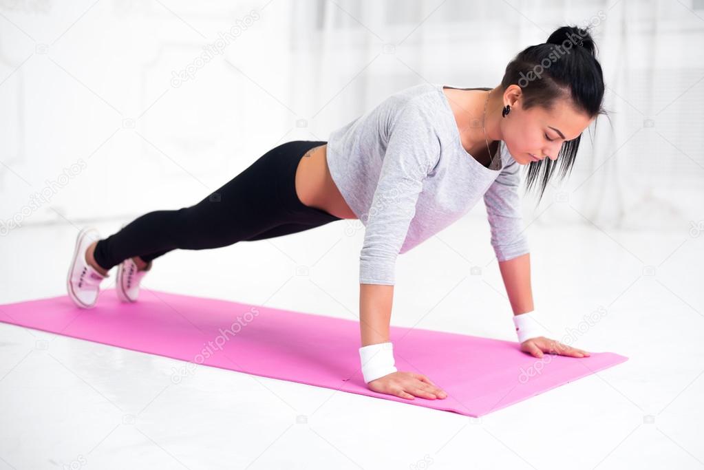 teenage girl doing push ups warming up