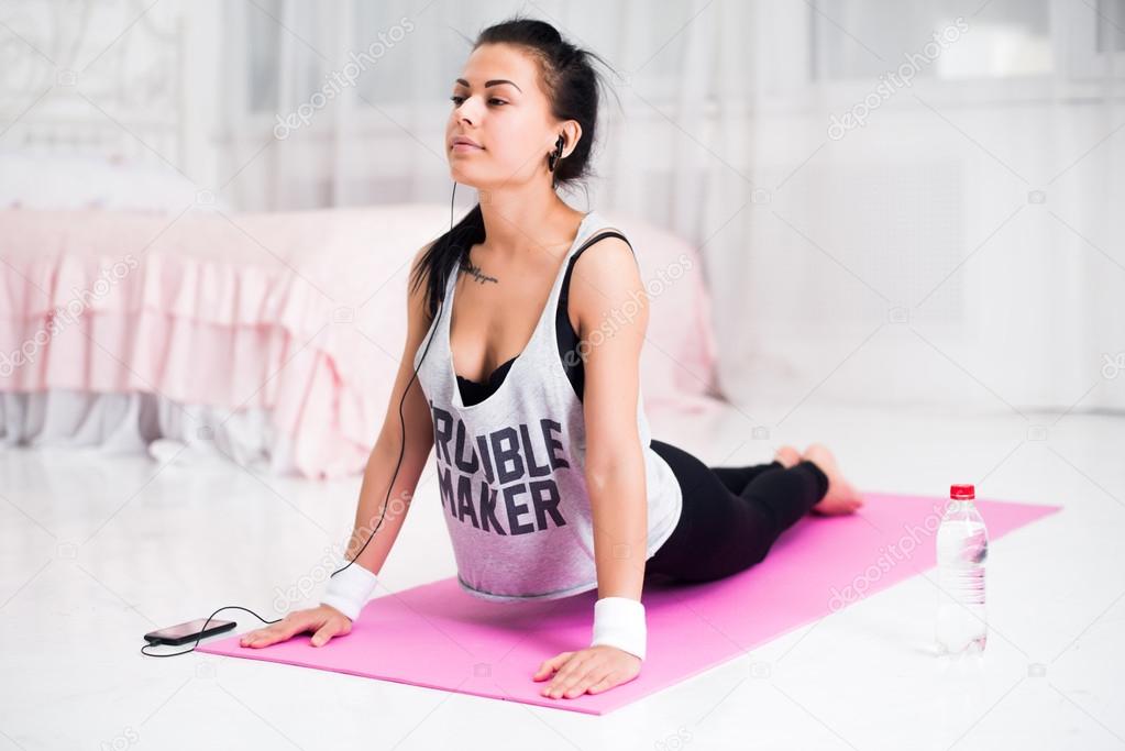 Girl doing warming up exercise for spine