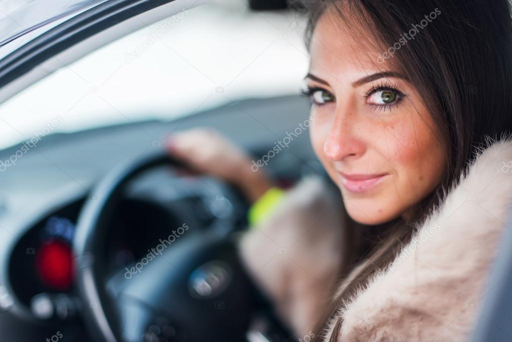 woman car driver in fur coat.