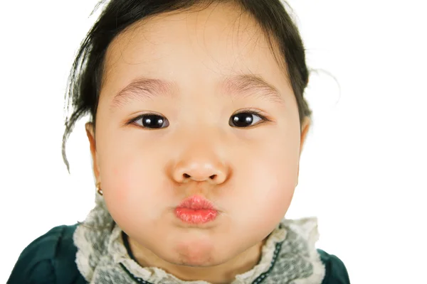 Little Asian girl inflates cheeks. — Stock Photo, Image