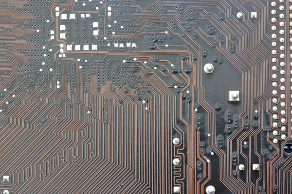 Kahverengi elektronik arka plan bilgisayar mainboard. — Stok fotoğraf