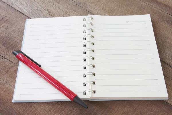 Notebook bianco e colore penna sul pavimento in legno . — Foto Stock