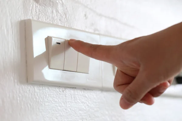 Fingers are off light switch in the house. — Stock Photo, Image