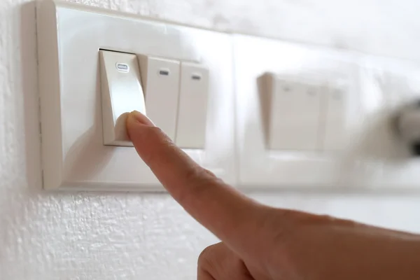 Fingers are off light switch in the house. — Stock Photo, Image