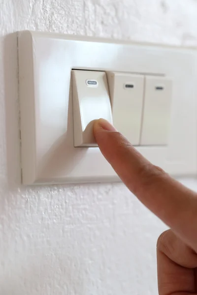 Fingers are off light switch in the house. — Stock Photo, Image