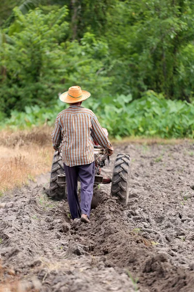 Les agriculteurs travaillent le chariot de commande pour reconditionner la culture du sol . — Photo