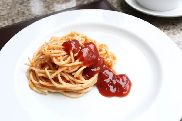 Makaron z sosem pomidorowym na białym naczyniu. — Zdjęcie stockowe