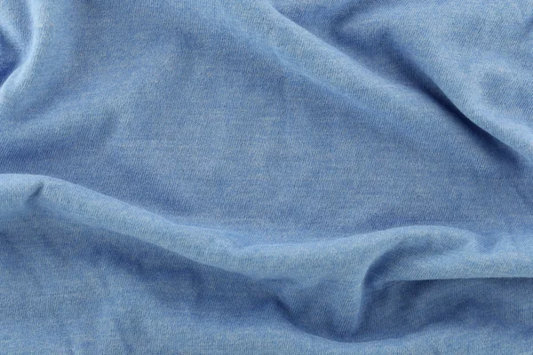Close-up van golfde blauwe katoenen stof. — Stockfoto