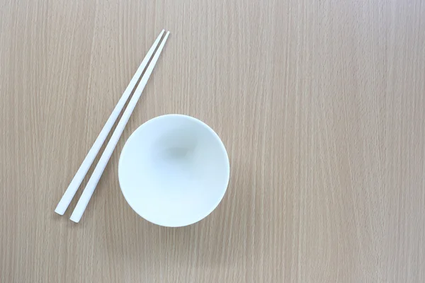 White chopsticks and dish in top view on wood background. — Stock Photo, Image