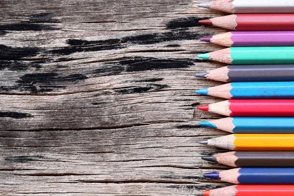 Closeup Color pencils concatenation on old wooden background. — Stock Photo, Image