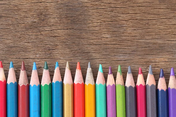 Closeup Color pencils concatenation on old wooden background. — Stock Photo, Image