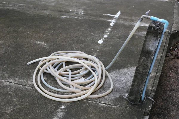 Old rubber tube on floor in the car park. — Stock Photo, Image