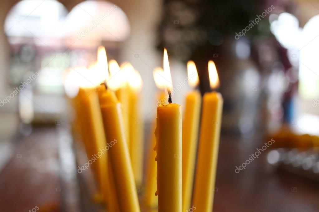 Candles light of burning at temple in abstract candles backgroun