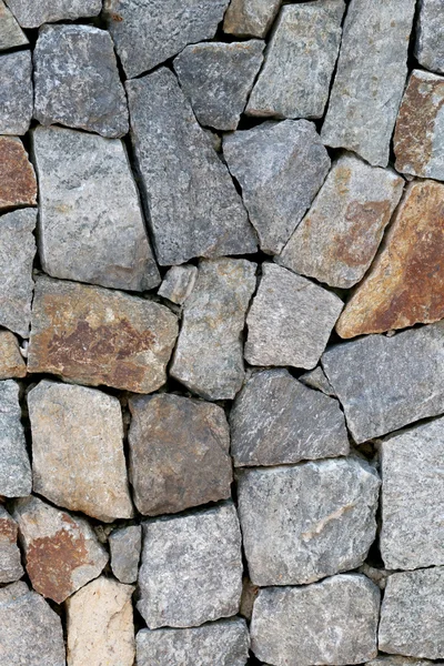 Oude stenen muur textuur in verweerde en natuurlijke oppervlakken. — Stockfoto