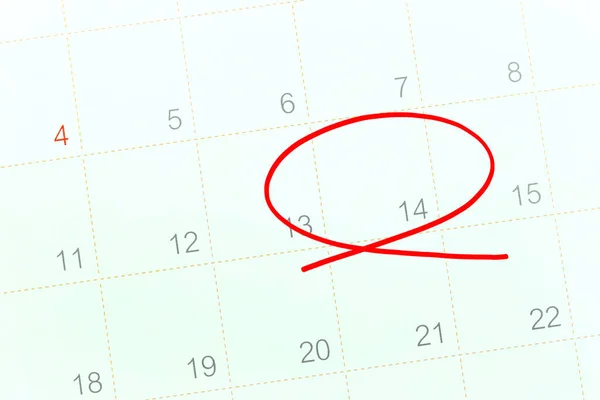 Red circle of the pen on the calendar paper shows the 14th for design in Valentine day concept.