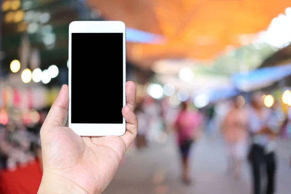 Hand Man Som Håller Smartphone Enhet Shoppingmarknaden Bakgrund Och Har — Stockfoto