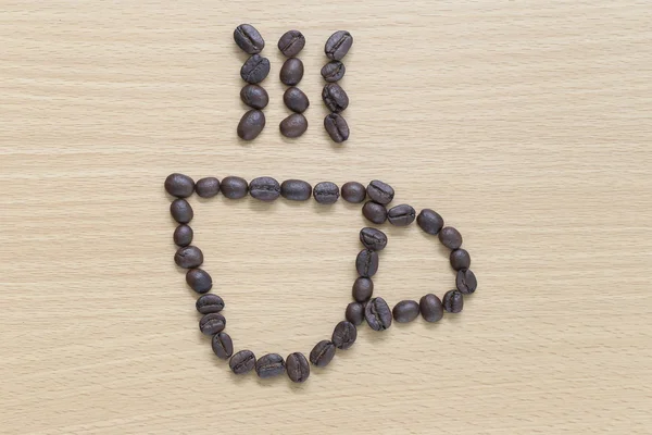 Coffee beans Placed in coffee cup shape. — Stock Photo, Image