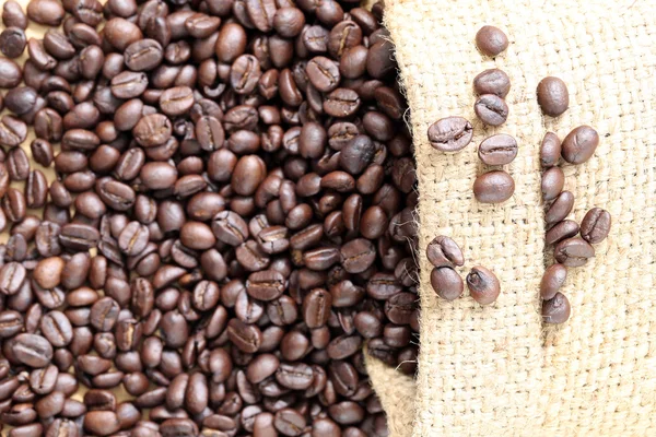 Coffee beans placed on bag sack. — Stock Photo, Image