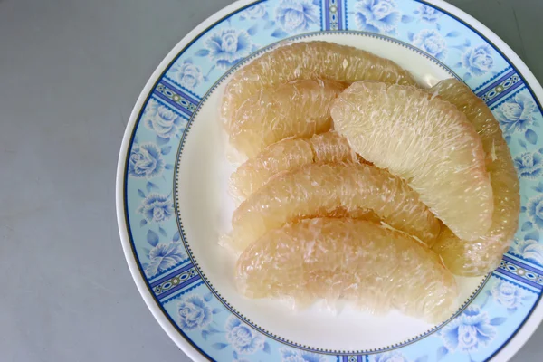 Fresh grapefruit on dish. — Stock Photo, Image