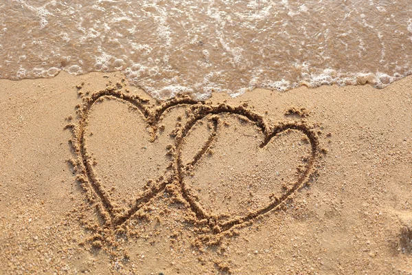 Beaches waves and heart shape drawn. — Stock Photo, Image