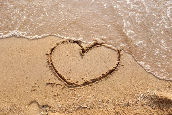 Beaches waves and heart shape drawn. — Stock Photo, Image