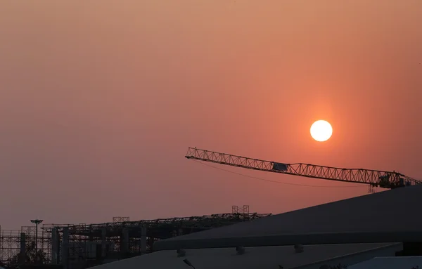 Coucher de soleil et usine en construction . — Photo