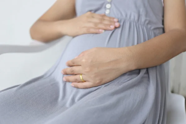Les femmes enceintes ont mis sa main sur son ventre . — Photo