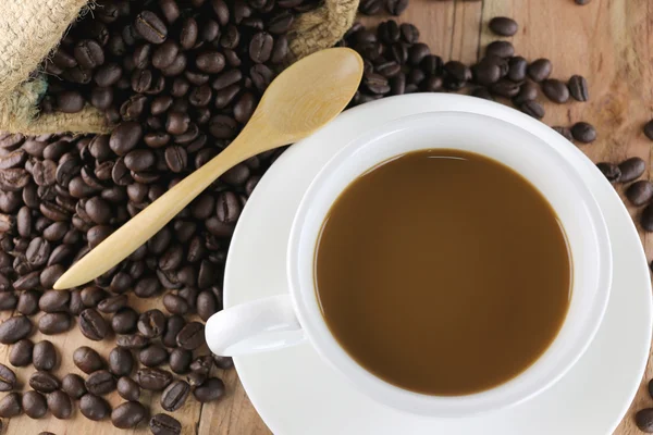 Taza de café blanco y granos de café tostados . —  Fotos de Stock