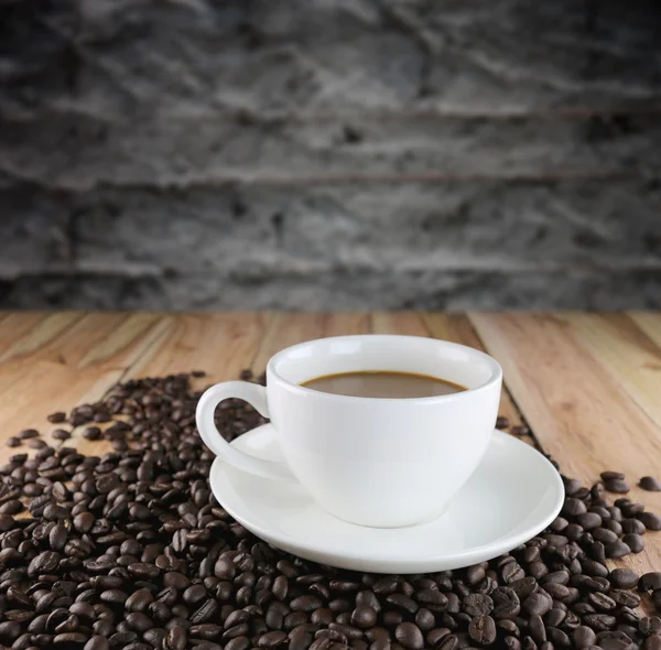 Copo de café branco e grãos de café torrados . — Fotografia de Stock