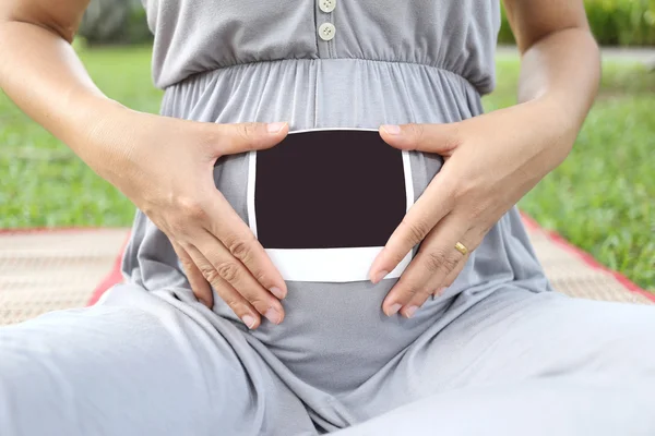 Les femmes enceintes montrent l'image de film d'échographie sur son ventre . — Photo