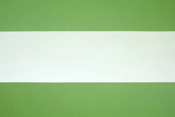 Parede de cimento pintada de verde e cor creme . — Fotografia de Stock