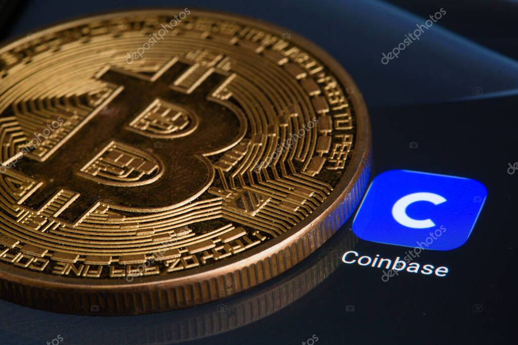 Coinbase logo on screen with Bitcoin coins. Ljubljana, Slovenia - April 06 2021