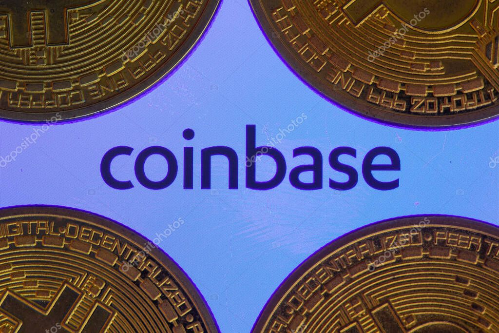 Coinbase logo on screen with Bitcoin coins. Ljubljana, Slovenia - April 06 2021