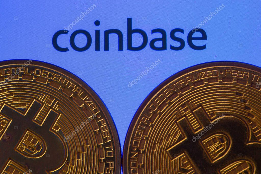 Coinbase logo on screen with Bitcoin coins. Ljubljana, Slovenia - April 06 2021