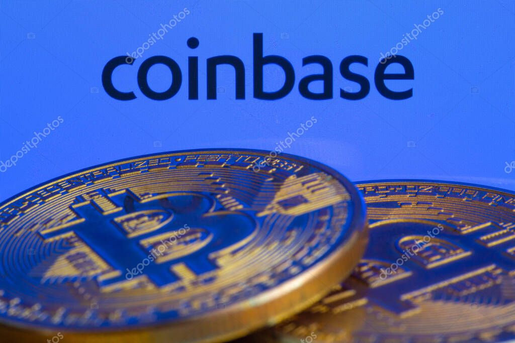 Coinbase logo on screen with Bitcoin coins. Ljubljana, Slovenia - April 06 2021