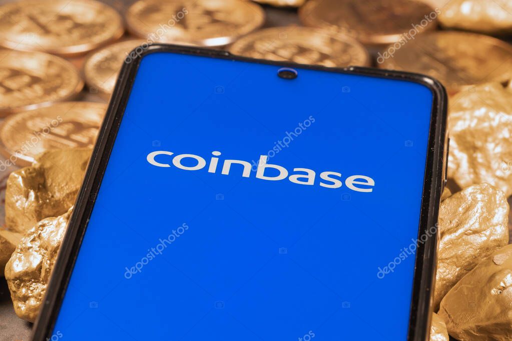 Coinbase crypto exchange logo on screen with Bitcoin coins. Ljubljana, Slovenia - April 12 2021