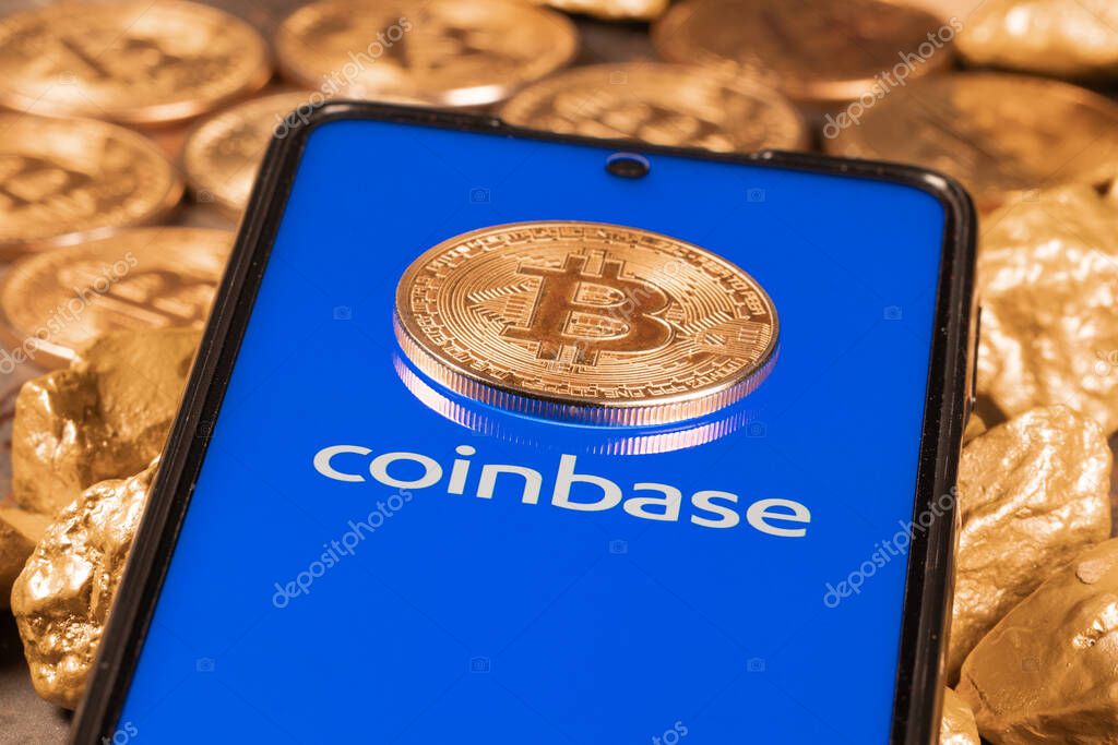 Coinbase crypto exchange logo on screen with Bitcoin coins. Ljubljana, Slovenia - April 12 2021
