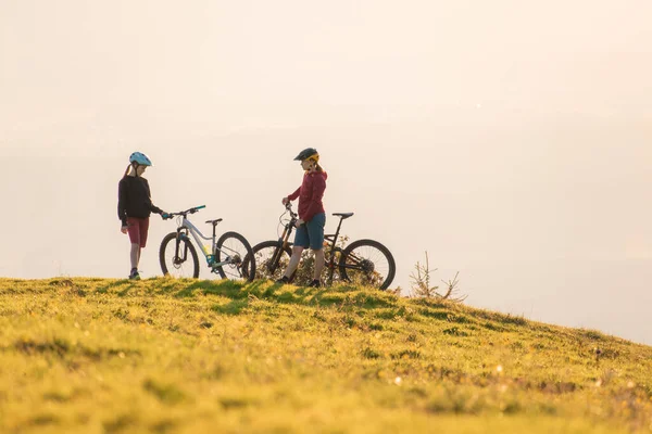 Two females on mountain bikes