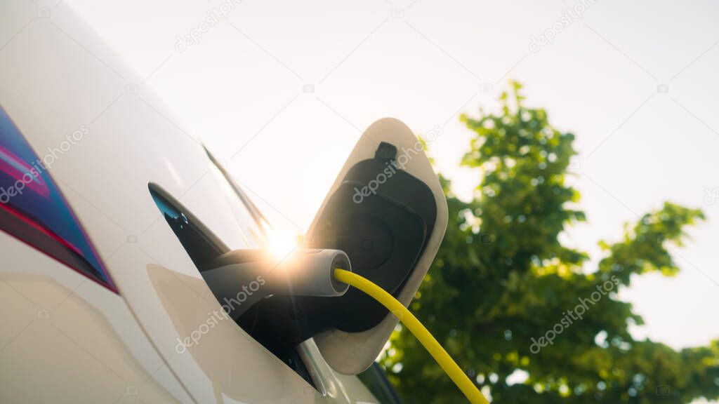 Electric car with charger plugged in