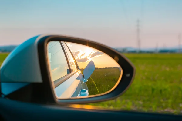 Electric car charge in a rear mirror — Stock Photo, Image