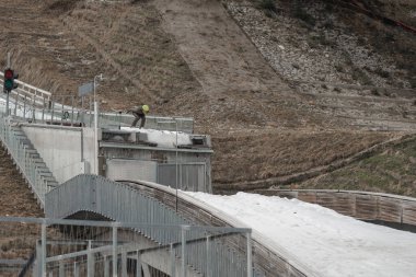 Profesyonel atlet kayakla atlama yapıyor, hızlı atlıyor, kayakla atlıyor, patlayıcı kalkış yapıyor ve uçuyor.