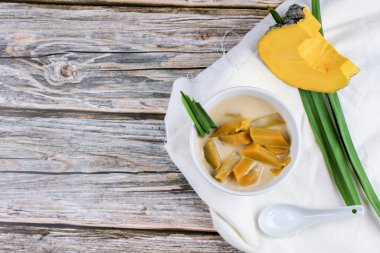 Tahta masa üzerinde hindistan cevizi sütü haşlanmış balkabağı (Buak-Phak-Tong) ve kopyalama alanı. Thai tatlı konsepti.