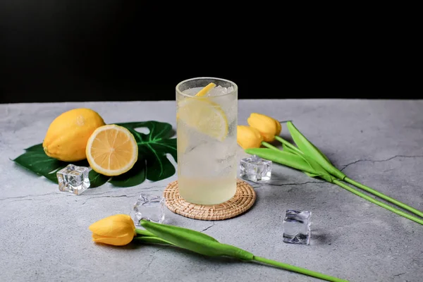 Lemonade. Drink with fresh lemons in fizzy sparkling water, juice refreshment. Lemon cocktail with juice and ice.