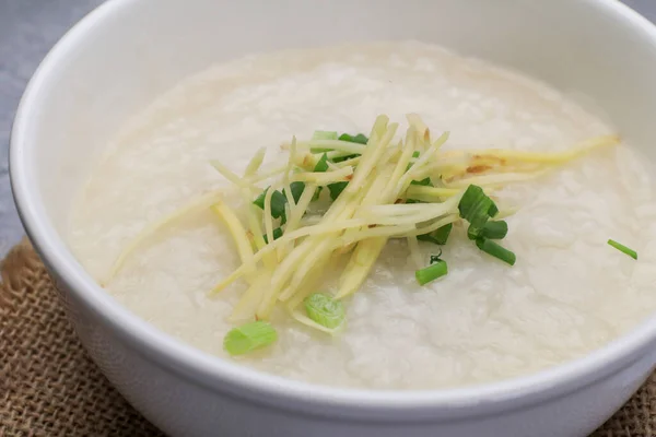 stock image Rice porridge or Congee with fresh ginger and coriander, is a favorite breakfast for south east asian people.