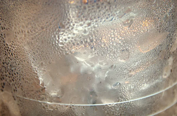 Close up of a plastic cup with ice cubes showing the concept of plastic pollution