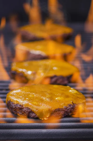 Cheeseburger su un barbecue caldo fiammeggiante — Foto Stock